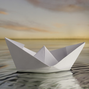 Paper boat in calm water